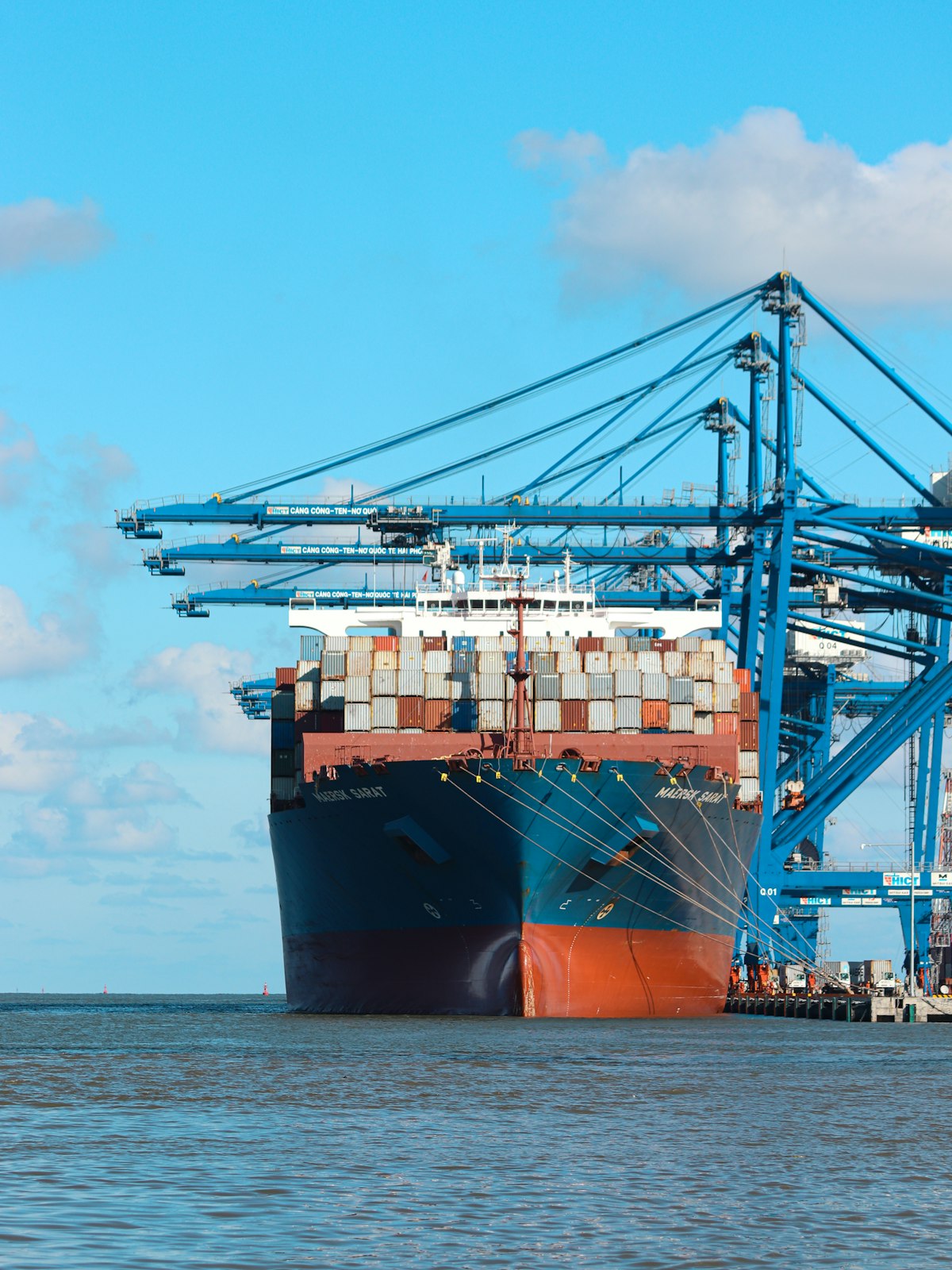 A large container ship berthed at a dock